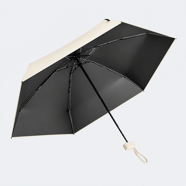 19 inch compact uv umbrella in off white opened, showing the black uv coating on the underside