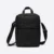 Kairos sling bag in black, front view with top handle and zip pocket
