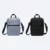 Kairos sling bag in grey and black, front view with shoulder strap