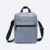 Kairos sling bag in grey, front view with top handle and zip pocket