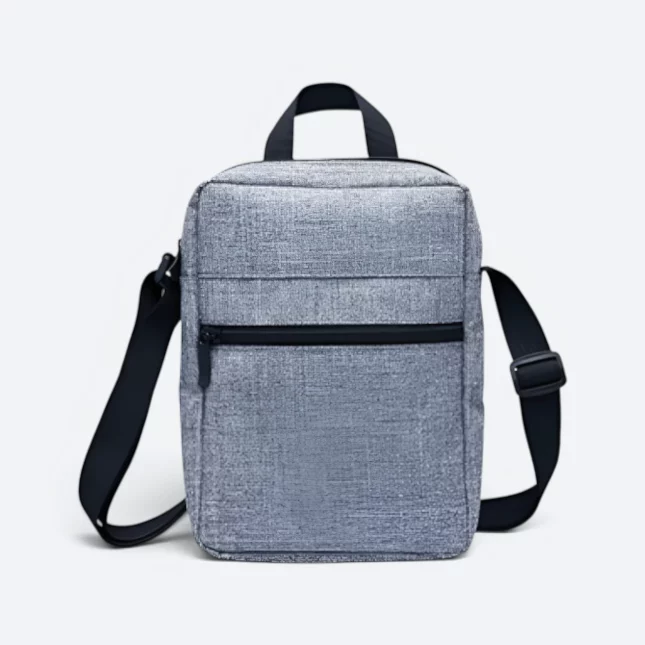 Kairos sling bag in grey, front view with top handle and zip pocket
