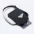 Kairos sling bag in black opened, showing card holder, car key and tablet inside