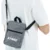 Kairos sling bag in grey worn over the shoulder with example printed logo