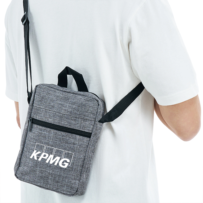 Kairos sling bag in grey worn over the shoulder with example printed logo